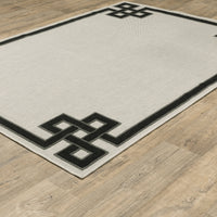 Torrey Beige & Black Outdoor Rug with a tri-colored loop pile pattern on a platinum flatwoven base.