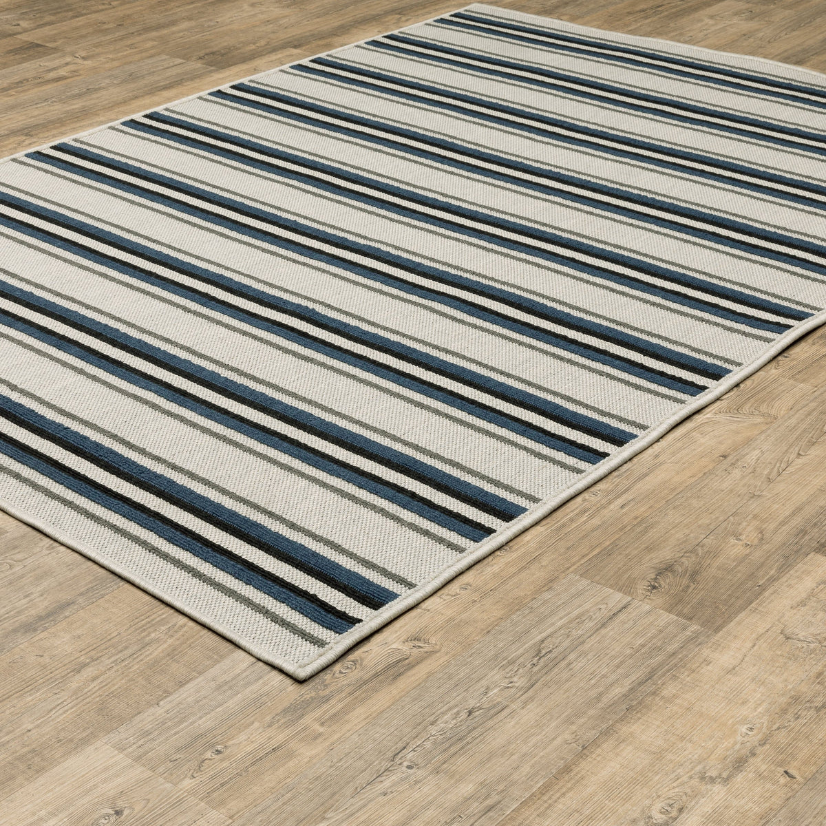 Torrey Beige & Blue Outdoor Rug with flatwoven and loop textures, featuring tri-colored stripes on a platinum base.