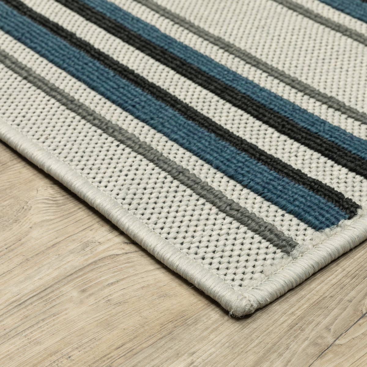 Torrey Beige & Blue Outdoor Rug with textured flatwoven base and tri-colored loop pile stripes.