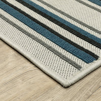 Torrey Beige & Blue Outdoor Rug with textured flatwoven base and tri-colored loop pile stripes.