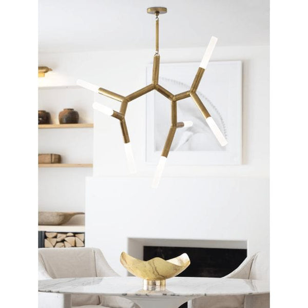 Traveler Chandelier with polished nickel branching arms and frosted acrylic bulb covers, hanging over a marble table.