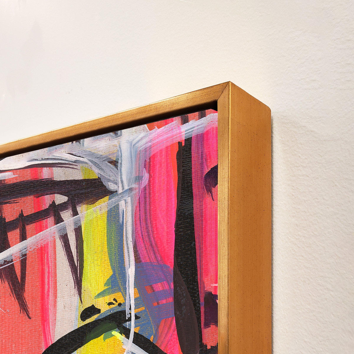 Abstract giclee canvas painting with vibrant pink, yellow, and black brushstrokes, framed in a gold-finished wood frame.