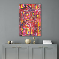 Abstract giclee canvas painting, "Traveling Through Eden," with vibrant red, pink, and yellow brushstrokes, framed above a gray cabinet.