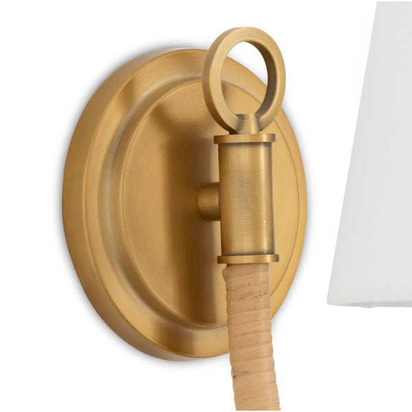 Treble Sconce Single: Brass wall sconce with a bent arm wrapped in natural bamboo and a white linen shade.