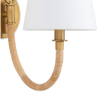 Coastal Treble Sconce with a bent arm, bamboo-wrapped design, polished brass, and white linen shade.