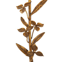 Close-up of a Trillium buffet lamp's antique gold leaf cast branch with delicate leaves and flowers.