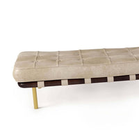 Tufted cappuccino leather gallery bench with dark wood frame, light straps, and gold legs.
