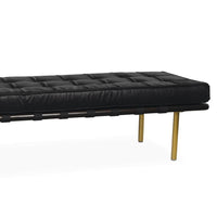 Modern black tufted leather gallery bench with dark wood frame and gold legs.