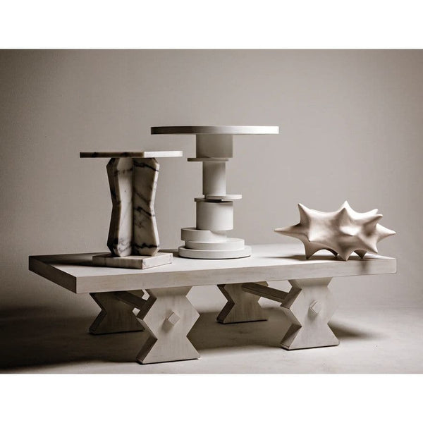 Vasco Square Marble Side Table, 23"H, with natural striations, next to a white side table and a shell sculpture.