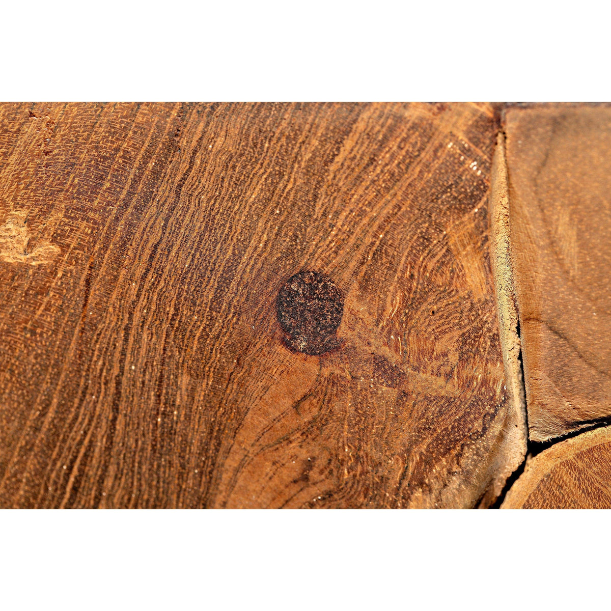 Close-up of Vert coffee table's solid teak wood surface, showing natural grain, swirls, and a dark knot.