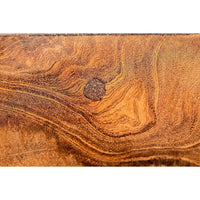 Close-up of Vert coffee table's solid teak wood surface, showing rich grain patterns and a natural knot.