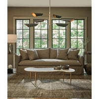 Large mid-century modern Vest Chandelier with six black conical shades and natural brass interior, illuminating a living room.