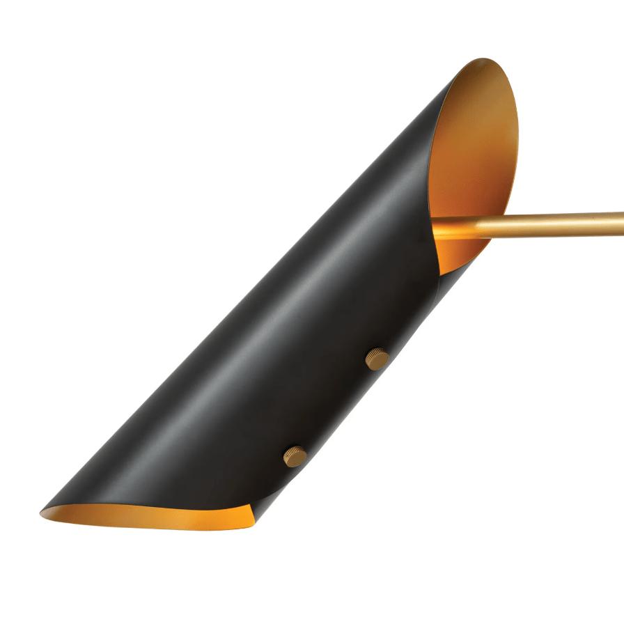Close-up of a black steel conical shade with a warm natural brass interior from the Vest Chandelier.