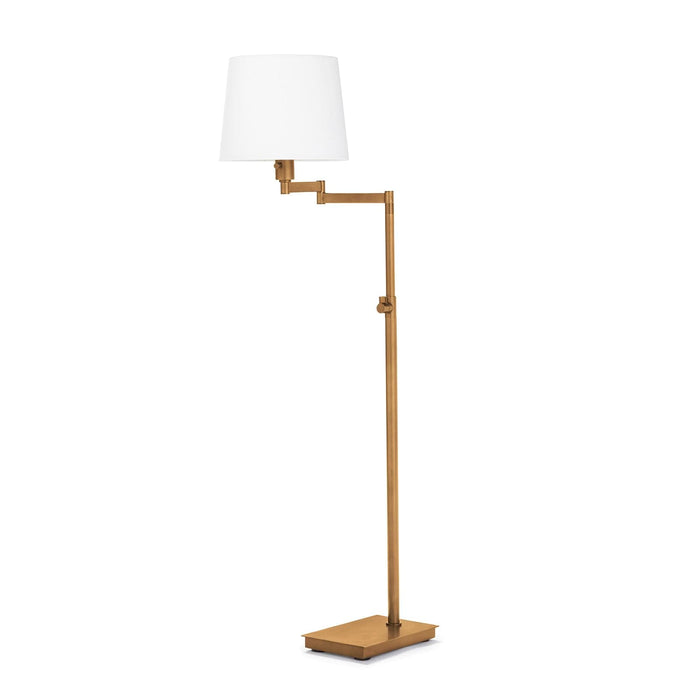 Virtue Floor Lamp in natural brass with an adjustable arm and white linen shade.