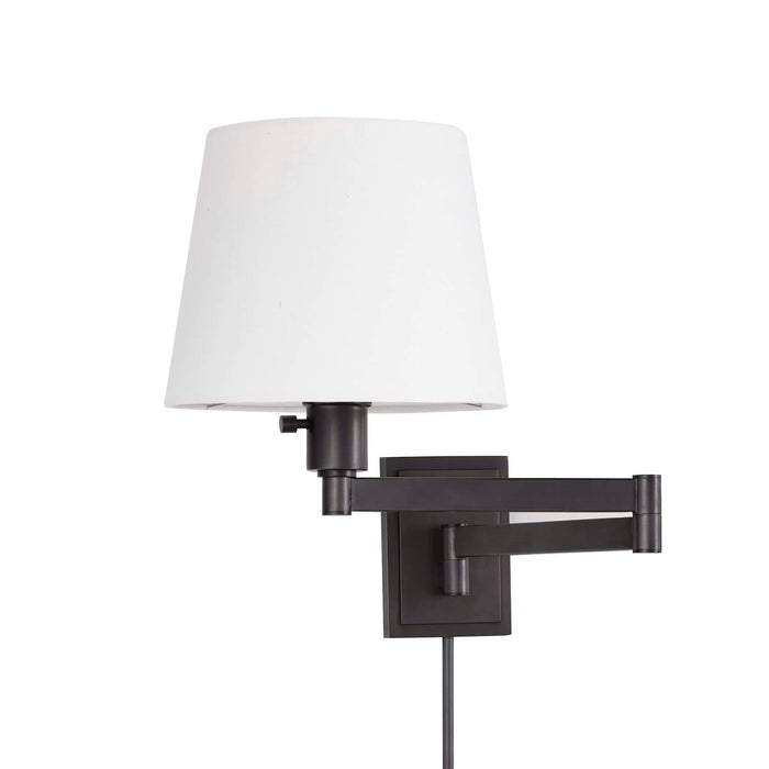 Virtue Sconce in oil rubbed bronze with an adjustable swing arm and white linen shade.