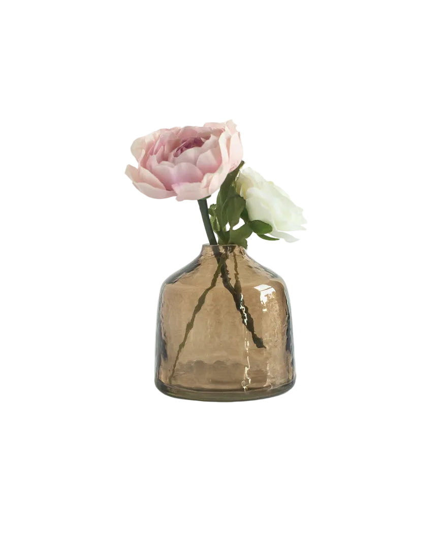 Smoked glass vase with a single pink flower on a white background