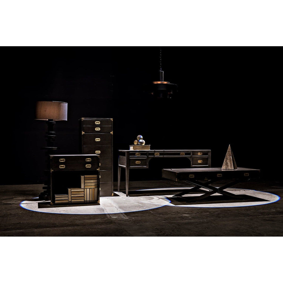 Wilton black steel floor lamp with stacked metal discs base and coordinated shade, next to dark wood furniture.