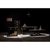 Wilton black steel floor lamp with stacked metal discs base and coordinated shade, next to dark wood furniture.