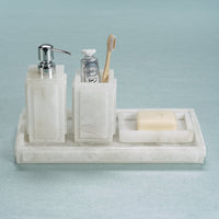 Marble bathroom set with soap dispenser, toothbrush holder, and soap dish on a light blue background