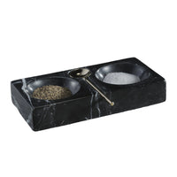 Black marble salt and pepper shaker set on a textured surface