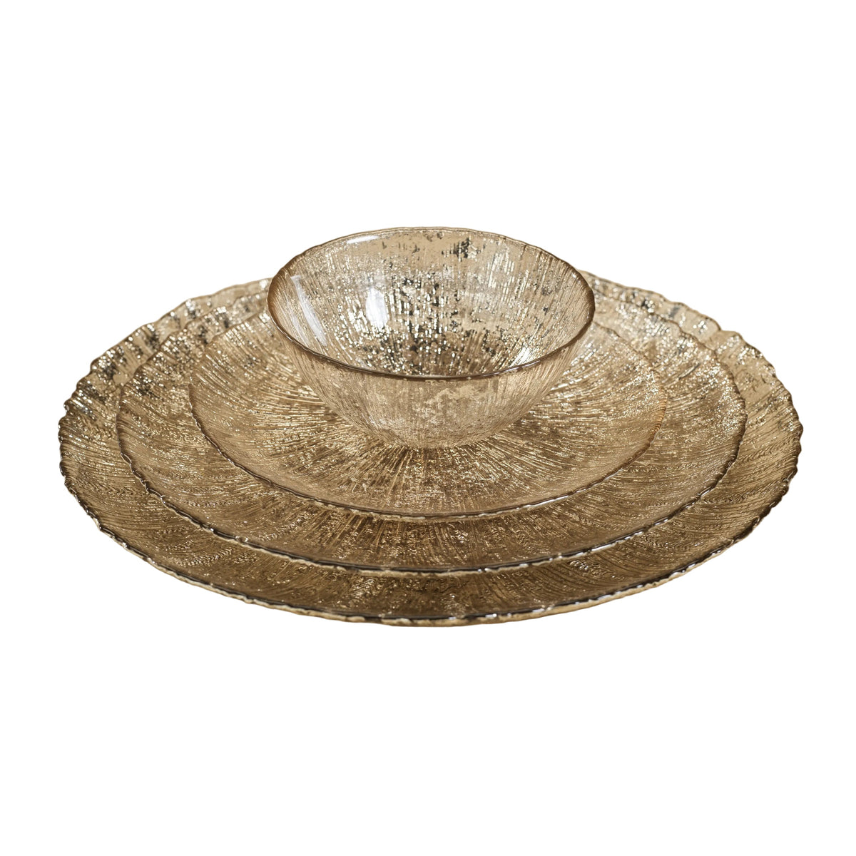 Set of three metallic bowls on a textured beige surface