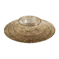 Set of three metallic bowls on a textured beige surface