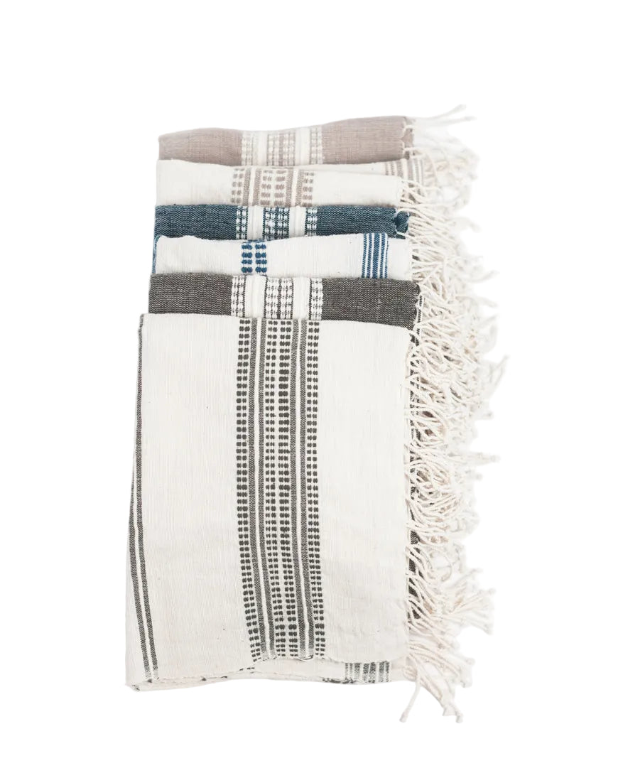 Textile with plaid pattern and fringes on a white background