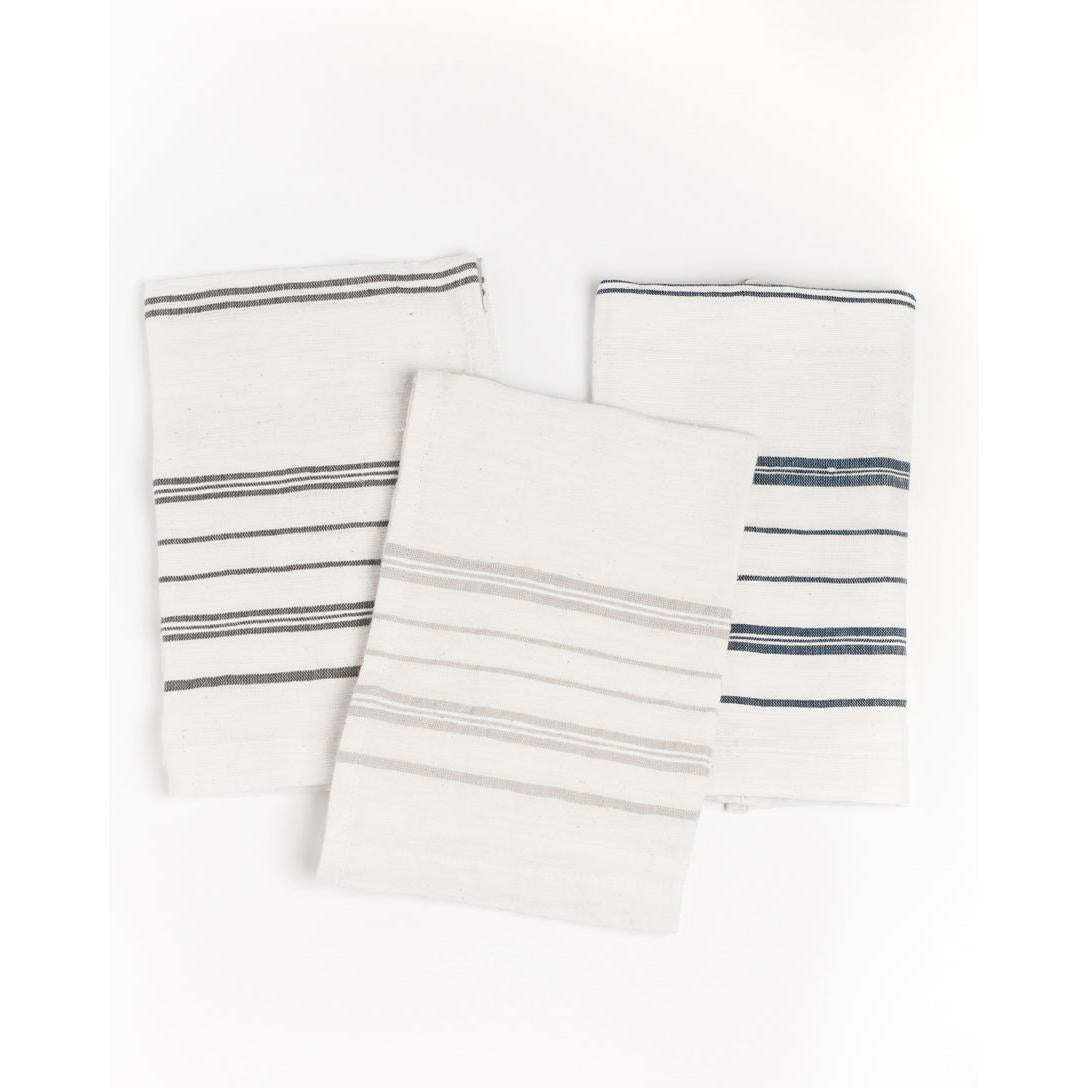 Set of three white towels with blue stripes on a white background