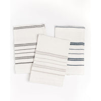 Set of three white towels with blue stripes on a white background