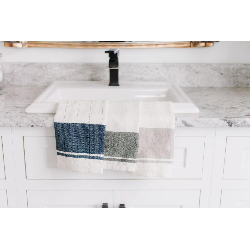 Kitchen sink with a hand towel draped over it