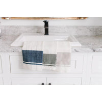 Kitchen sink with a hand towel draped over it